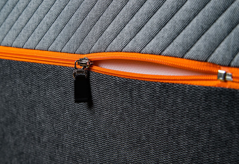 Recore mattress cover focusing on the neon orange zipper and two-tone grey fabric