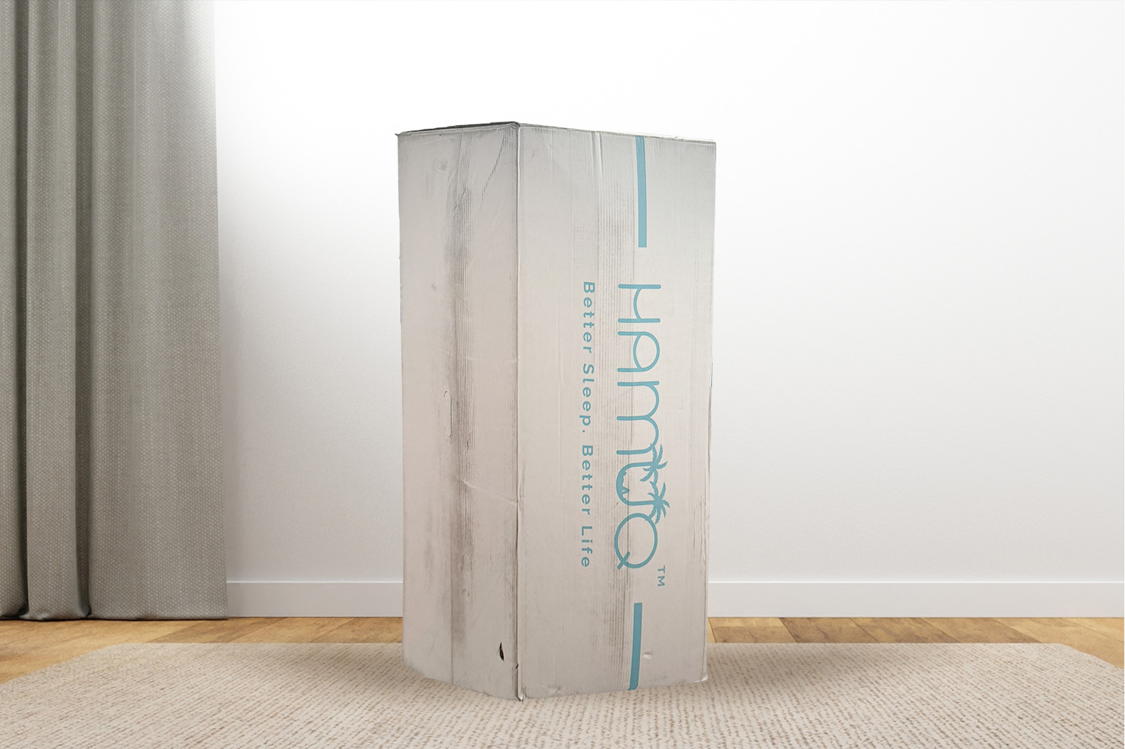 MattressNameBox MattressReviewscom The hamuq original hybrid box standing upright on a carpet in a bedroom